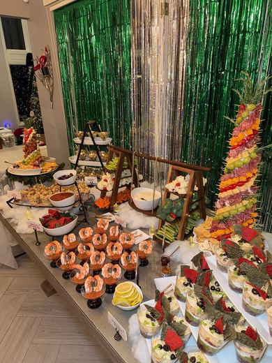 An abundant dessert and fruit display with a tiered fruit tower
